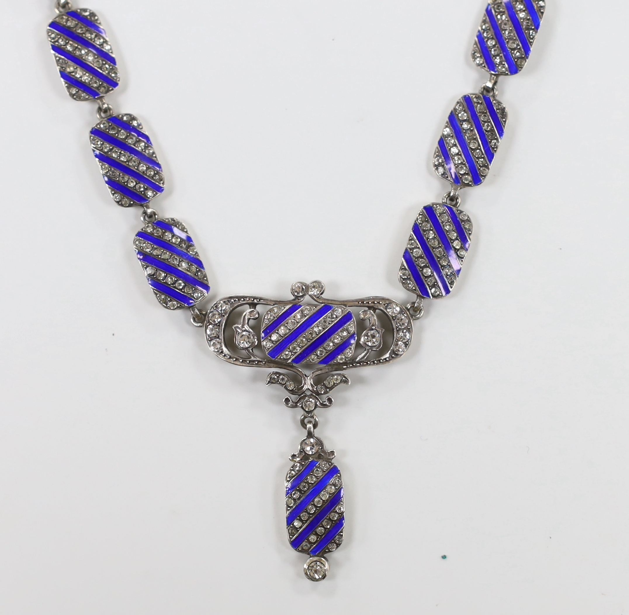 A stylish sterling, paste and blue enamel set drop pendant necklace, overall 43cm.